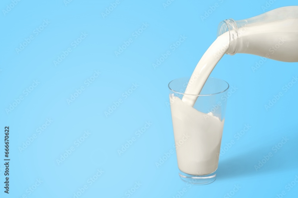 Pouring fresh tasty milk in glass Pouring fresh tasty milk in glass