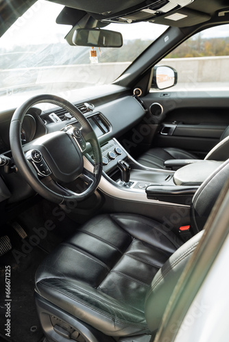 Luxury car leather interior, steering wheels, car interior, driver's seat, front of the car, windshield.