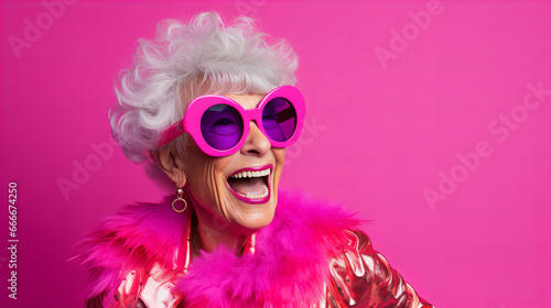 Happy mature woman wearing pink sunglasses and a pink jacket