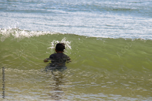 Asian little boy having fun playing in the sea, Layan Beach, Phuket, Thailand