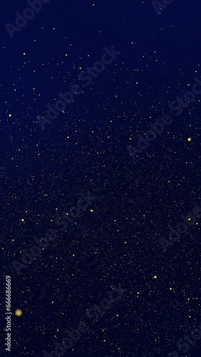 Gold tiny dots glitter on dark blue gradient background that spin. Vertical abstract stars backdrop party or Christmas holidays Valentine's day and New Year concept with copy space