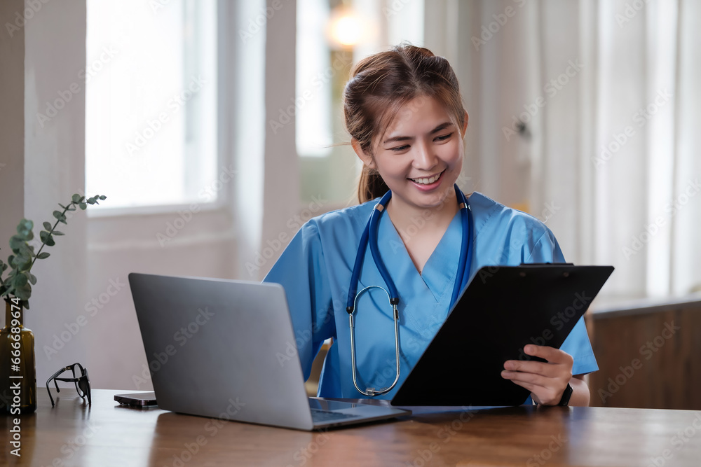Smiling female doctor working with her laptop in the consultation. Smiling female doctor working with her laptop in the consultation.