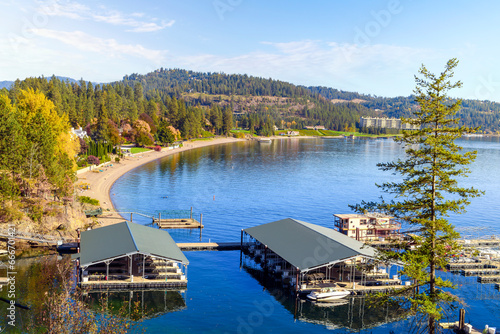 View from the Tubbs Hill hiking trail of the Sanders Beach lakefront community of homes, the sandy beach, and 11th Street Marina along the lake in Coeur d'Alene, Idaho USA at autumn. photo