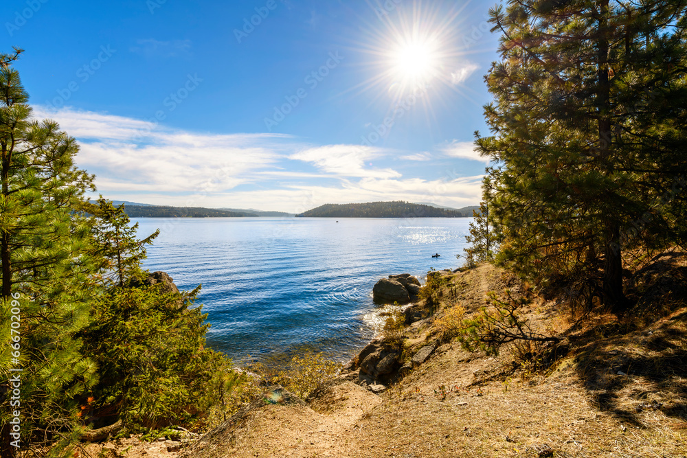 Late afternoon sun and autumn view from the Tubbs Hill hiking trail along the lake in the Northwest Panhandle resort town of Coeur d'Alene, Idaho USA. Late afternoon sun and autumn view from the Tubbs Hill hiking trail along the lake in the Northwest Panhandle resort town of Coeur d'Alene, Idaho USA.