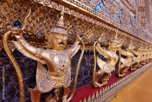Golden sculptures of Garuda and Naga, Wat Phra Kaew (Temple of the Emerald Buddha), Bangkok, Thailand photo