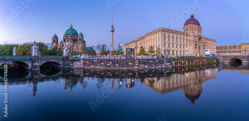 View of Berliner Dom, Berliner Fernsehturm and Humboldt Forum reflecting in River Spree at dusk, Berlin, Germany photo