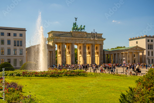 View of Brandenburg Gate and visitors in Pariser Platz on sunny day, Mitte, Berlin, Germany photo