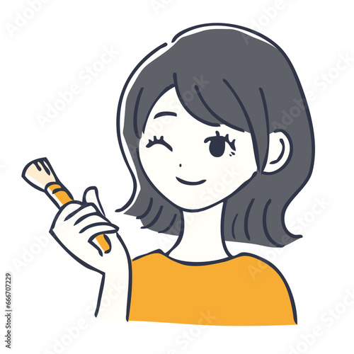 化粧ブラシを持つ笑顔の女性