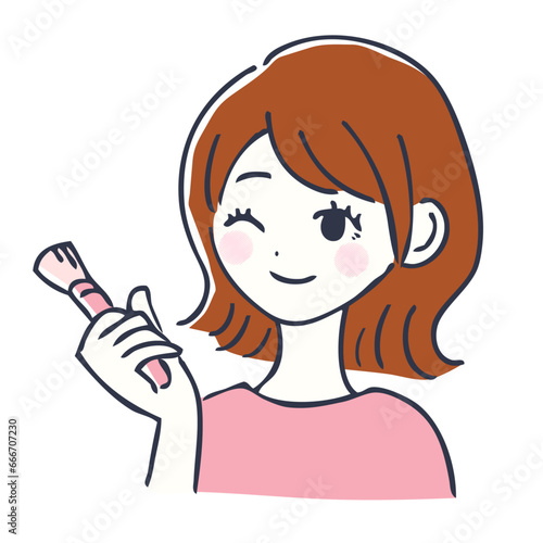 化粧ブラシを持つ笑顔の女性