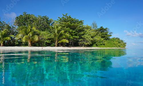 Tropical islet in the lagoon of Huahine island seen from sea surface, natural scene, French Polynesia, south pacific, Society Islands photo