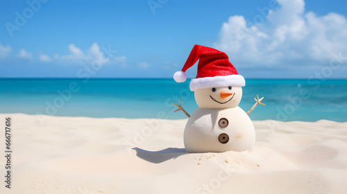 Christmas holidays on a sunny beach: sand snowman with Santa hat photo