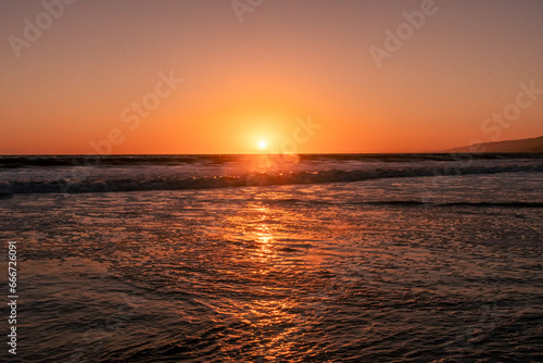 Sunset into the Pacific Ocean from a west coast beach in Southern California