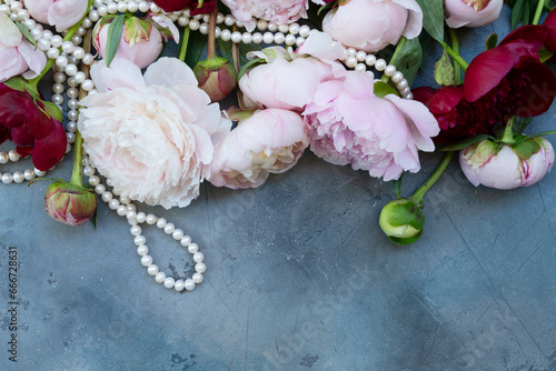 Fresh peonies flowers on dark gray desk, copy space photo