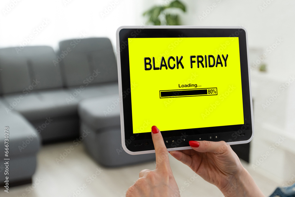 Laptop and small cart on white marble table. Black Friday Sale online