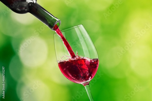 Pouring tasty alcohol red wine in glass