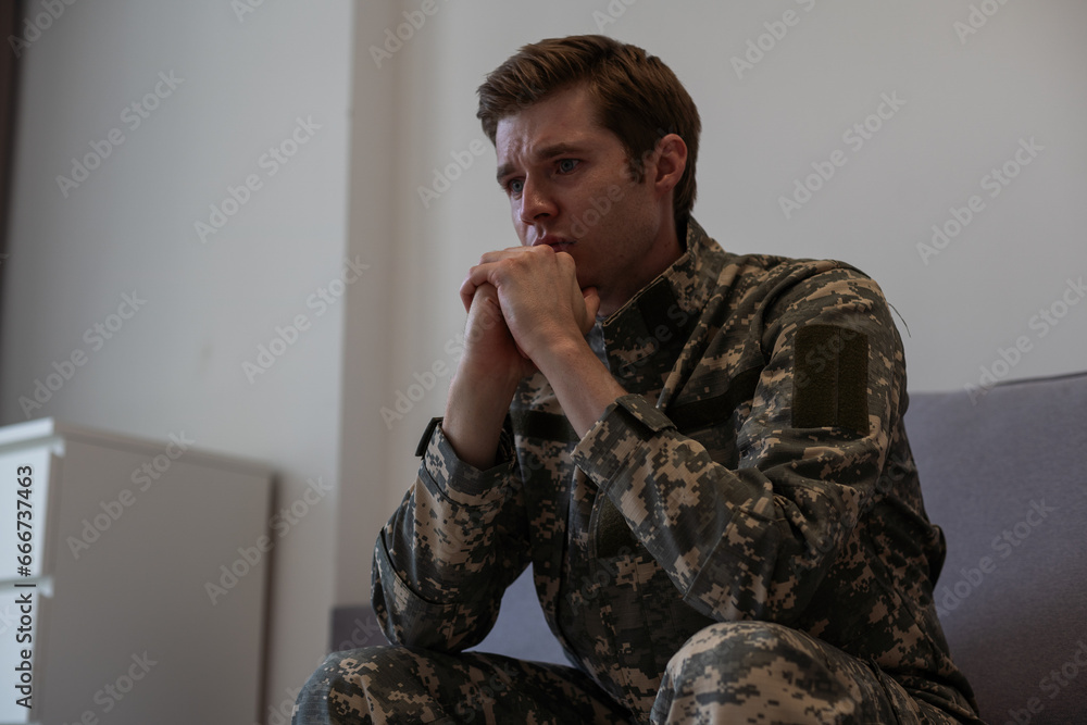 Portrait of middle aged sad, desperate military man looking thoughtful at camera during therapy session. Disabled soldier suffering from depression psychological trauma. PTSD concept. Horizontal shot