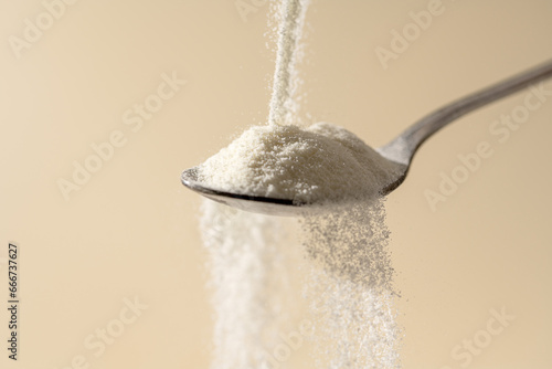 Collagen protein powder pouring in a spoon. Food beauty and health supplement