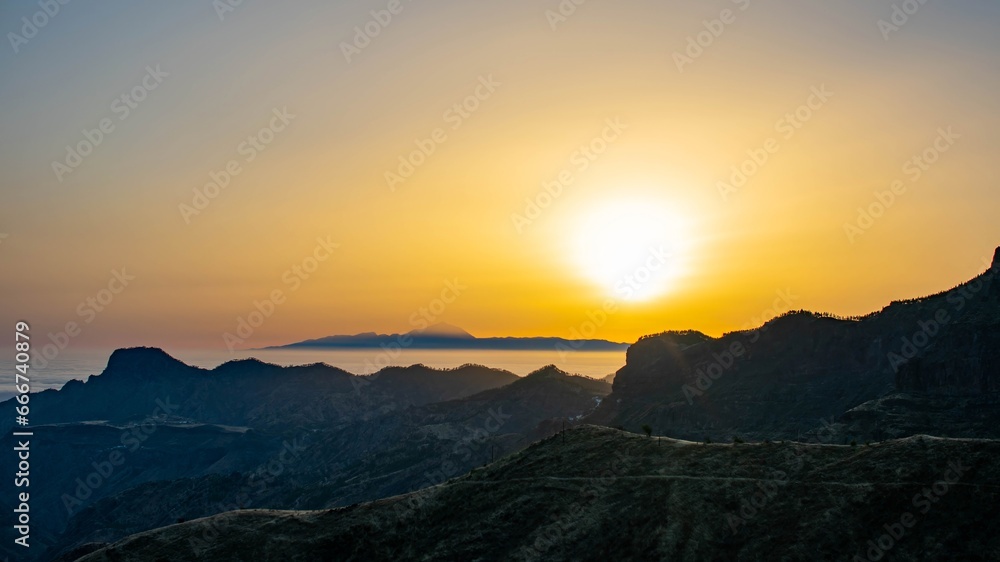 Landscape of the island of Tenerife with the sun above and the sea of clouds below from the island of Gran Canaria.