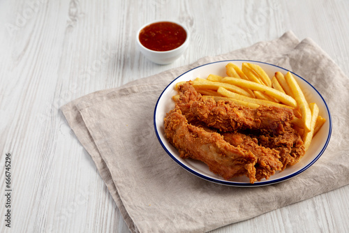 Crispy Chicken Strips with French Fries and Sour-Sweet Sauce. Copy space.