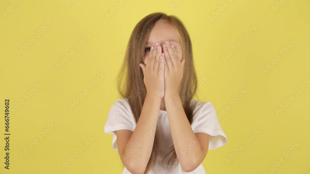 Little kid girl 7-8 years old in casual clothes blowing sending air kiss, isolated over yellow color background wall in studio. Childhood lifestyle concept Little kid girl 7-8 years old in casual clothes blowing sending air kiss, isolated over yellow color background wall in studio. Childhood lifestyle concept