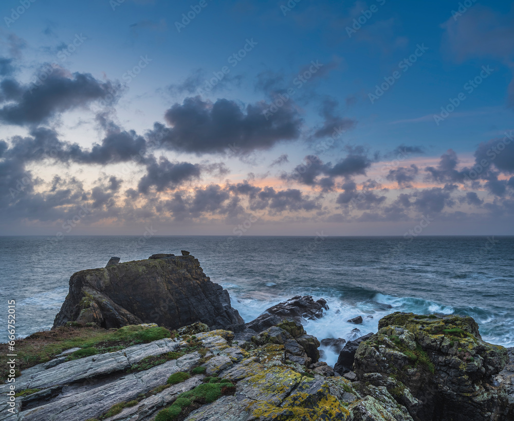 Beautiful dramatic Summer dawn over Lizard Point in Cornwall UK with lovely glowing sky and clouds