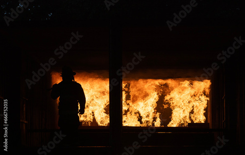 Firefighters in fire simulation training facility