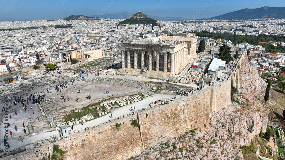 Aerial drone cinematic shot above unique Acropolis hill, the Parthenon, Odeon of Herodus Atticus and theatre of Dionysus, Athens historic centre, Attica, Greece