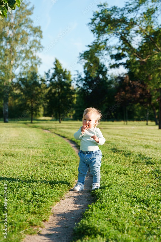 Happy little child baby 1 year in the park in summer, outdoor walking Happy little child baby 1 year in the park in summer, outdoor walking