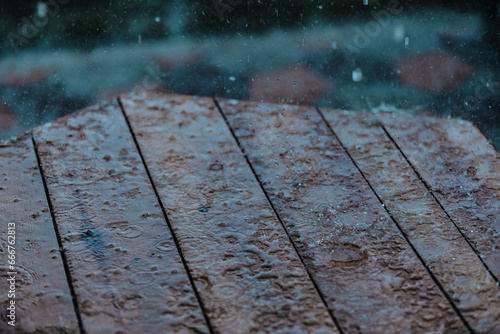 Raindrops on wooden table surface