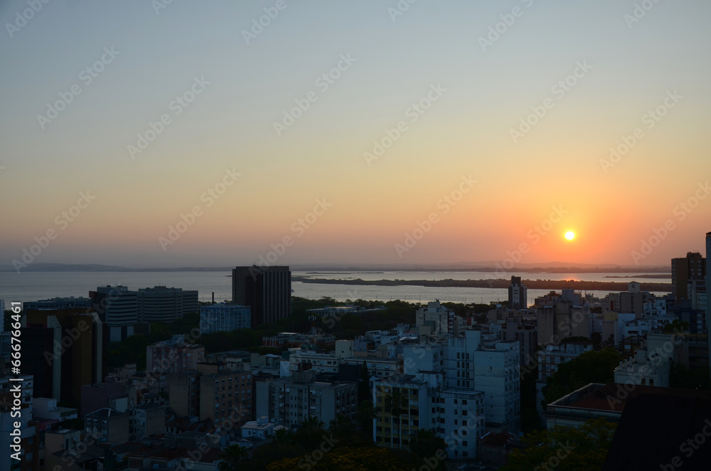 Fototapeta premium Aerial view of the central area of Porto Alegre with the Guaiba River in the background - clear sky sunset