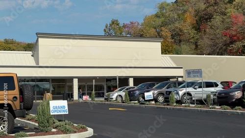 A daytime exterior DX establishing shot of an unbranded, generic American grocery store. Blank marquee for customization.	 photo