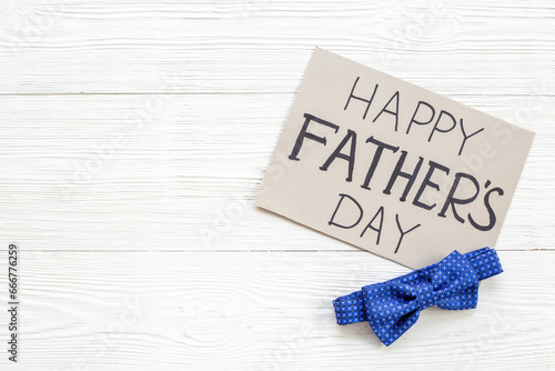 Happy Fathers day handmade postcard with blue bow tie, top view