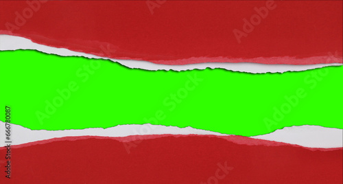 Hole ripped in red paper on green. Copy space. Christmas background.