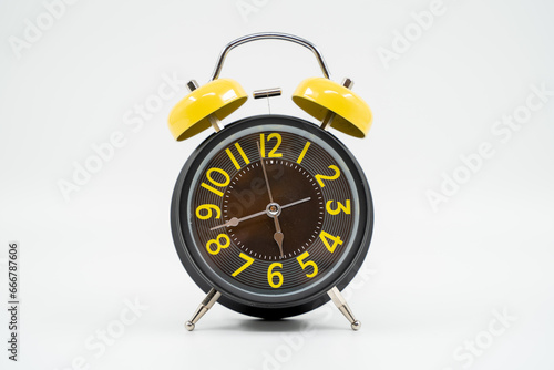 Yellow black table alarm clock on white background isolated.