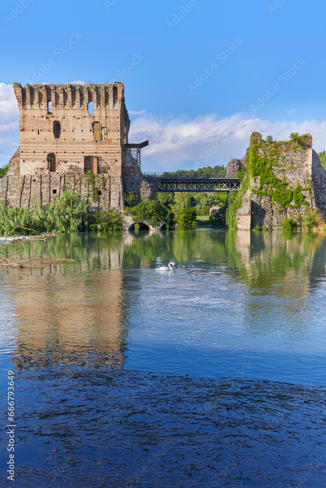 Beautiful view of the medieval bridge over the Minico (Ponte Visconteo) from the village of Borghetto. Italy.