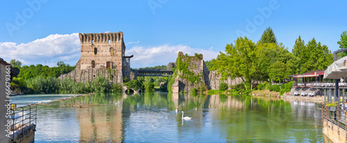 Beautiful view of the medieval bridge over the Minico (Ponte Visconteo) from the village of Borghetto. Italy. photo