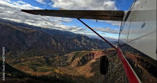 Wallpaper Mural Airplane pov shot of wing flying through scenic mountains  Torontodigital.ca
