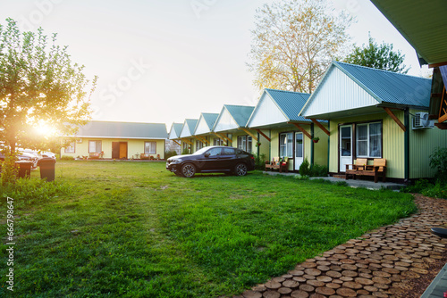 One-story motel houses. Cozy and comfortable accommodation with parking.