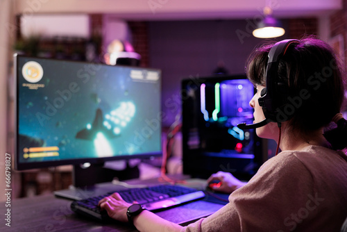 Obraz na plátne Professional gamer engaging in online competitive multiplayer tourney using cutting edge gaming system, captivating fans during live stream
