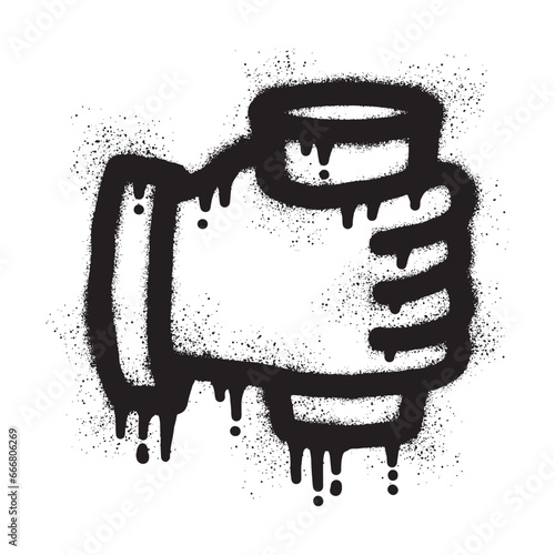 Graffiti of a hand holding a cup with black spray paint