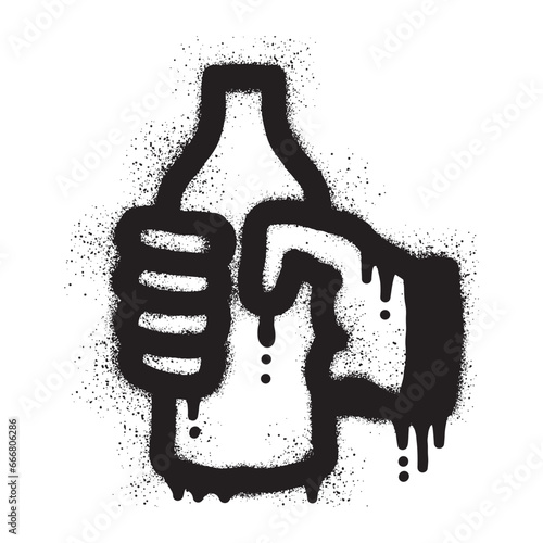 hand holding a bottle with black spray paint