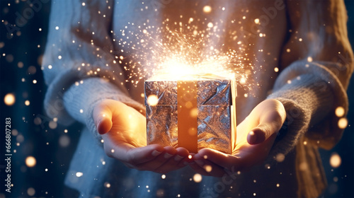 opening a Christmas present with sparkling Christmas lights © Melinda Nagy