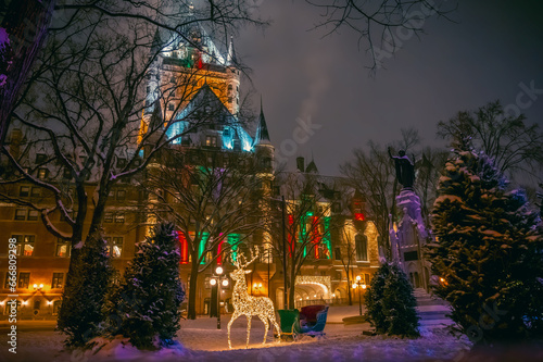 Place d'Armes and historic Fairmont Le Chateau Frontenac hotel during winter holidays, with Christmas decorations including reindeer and sleigh, old Quebec City, Canada. Photo taken in December 2022.