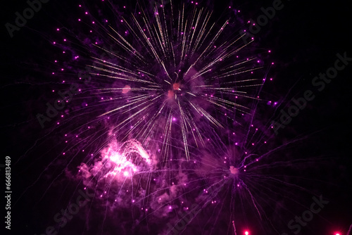 Fireworks explode in the night sky. Selective focus.