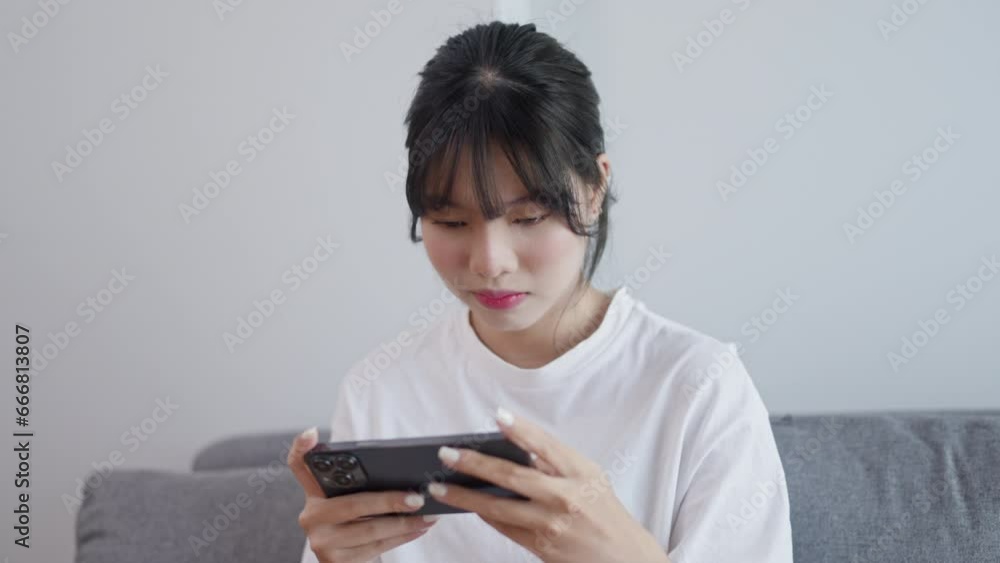 serious woman concentration focus online gaming with smartphone .