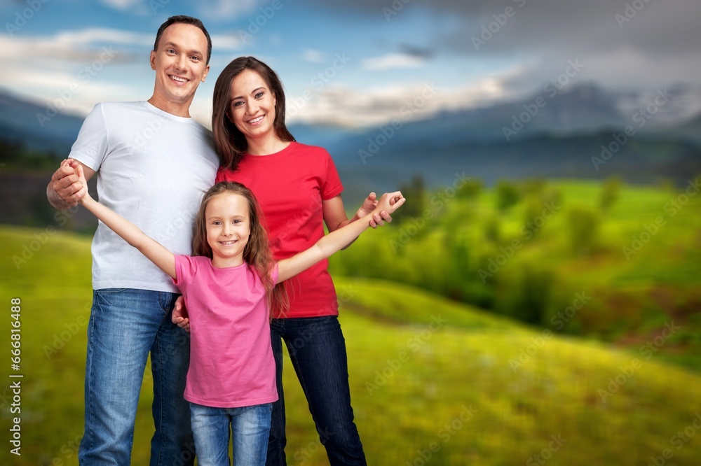 Cheerful parents with happy child at park. Cheerful parents with happy child at park.