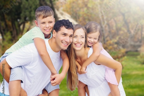 Cheerful parents with happy child at park. © BillionPhotos.com