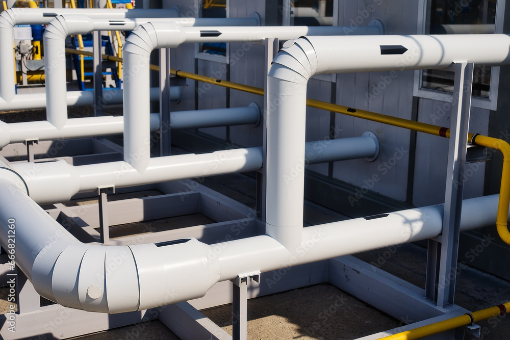 Pipes of gas boiler room outside on summer day. Concept of beginning of heating season. Gasification of population. Background. Pipes of gas boiler room outside on summer day. Concept of beginning of heating season. Gasification of population. Background.