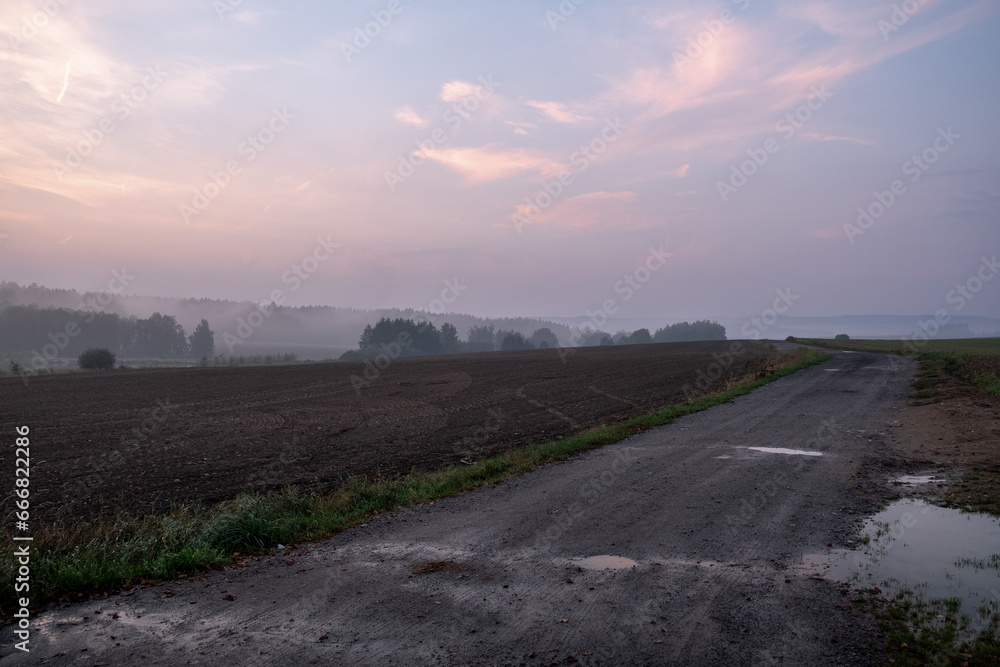 misty sunset, plowed field, sunset with red clouds, path between fields misty sunset, plowed field, sunset with red clouds, path between fields