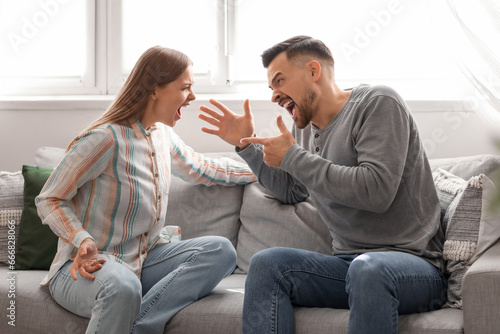 Angry young couple quarreli...